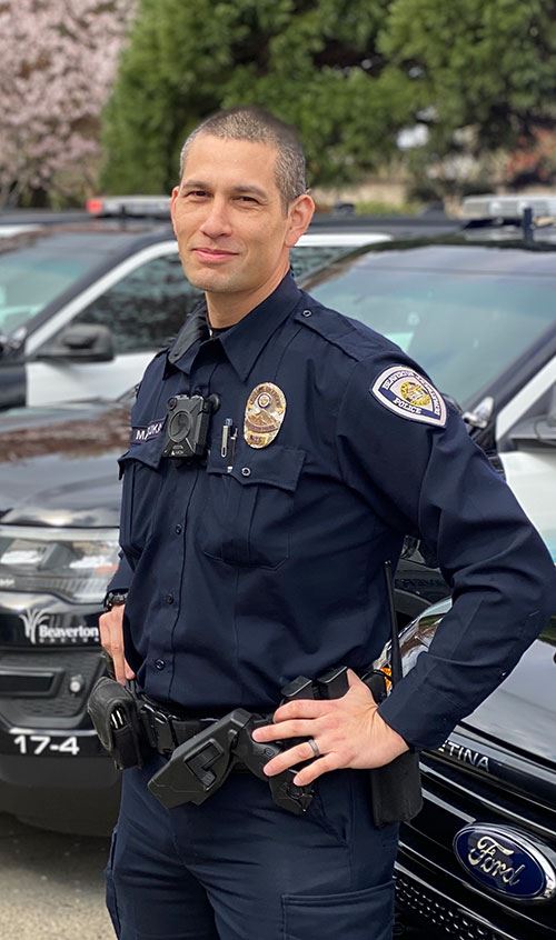 Officer standing and wearing a body worn camera