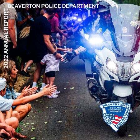motorcyle patrol officer greets children at parade