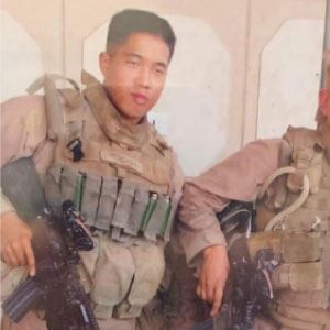 person in full military combat uniform